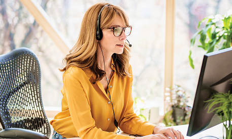 A DUPIXENT MyWay® nurse educator wearing a headset and yellow shirt
