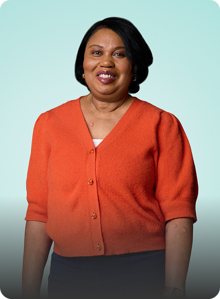 Thelma, a 59 year old CSU patient who is on DUPIXENT, standing and smiling